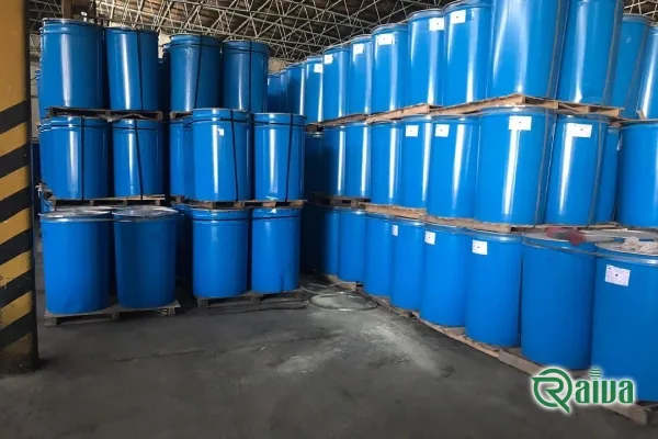 Aseptic tomato paste in bulk steel drums beside fresh tomatoes (view 3)