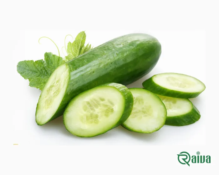 Green cucumbers beside cut slices