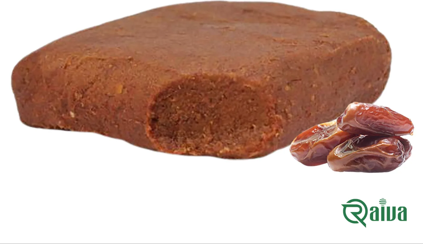 A pressed block of smooth brown date paste beside two whole dates