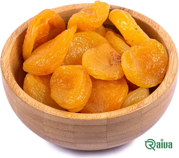 Orange dried apricot halves in a wooden bowl