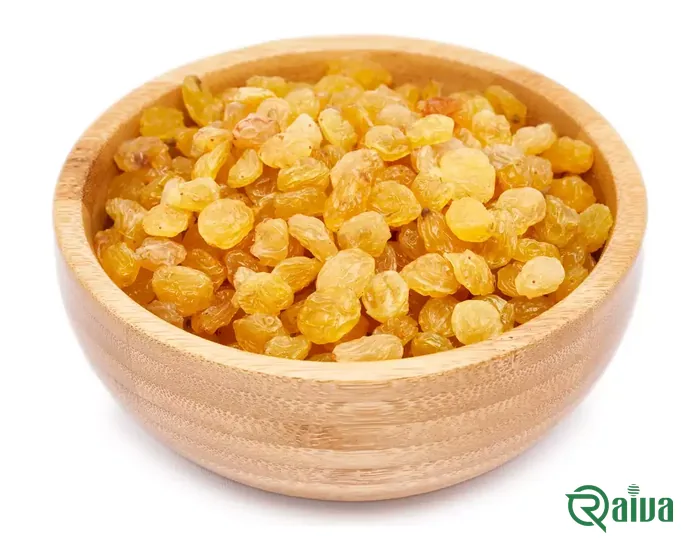 Amber-gold seedless raisins heaped in a wooden bowl