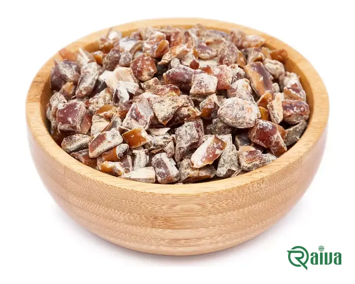 Diced date pieces cut to a uniform size, in a wooden bowl