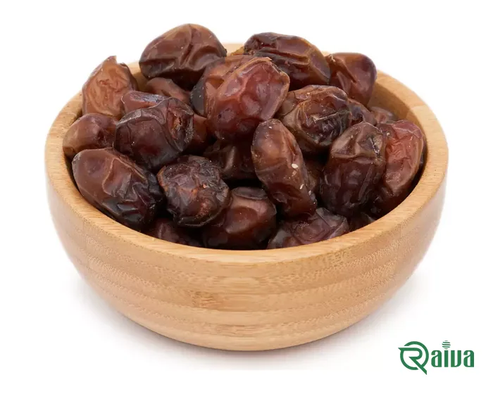 Reddish-brown semi-dry Khasouei dates in a wooden bowl
