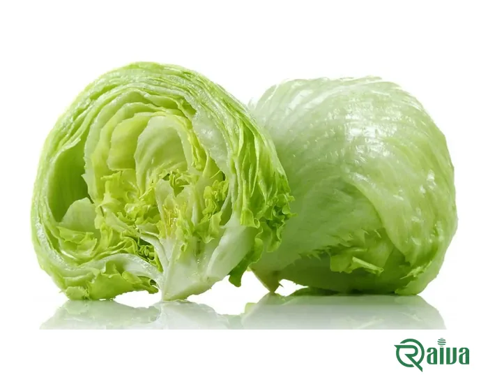 A head of iceberg lettuce beside a cut half