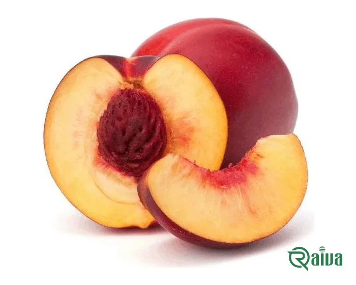 Ripe peaches, one halved to show the stone