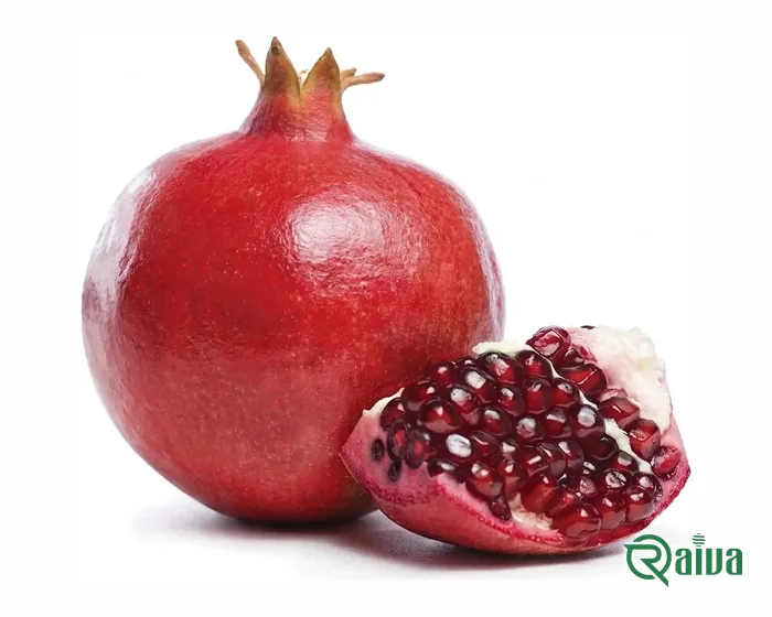 A whole red pomegranate beside a broken wedge showing its arils