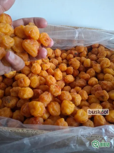 Dried plums with a soft amber skin in a wooden bowl (view 6)