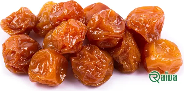Dried plums with a soft amber skin in a wooden bowl (view 9)