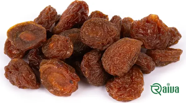 Dried plums with a soft amber skin in a wooden bowl (view 11)