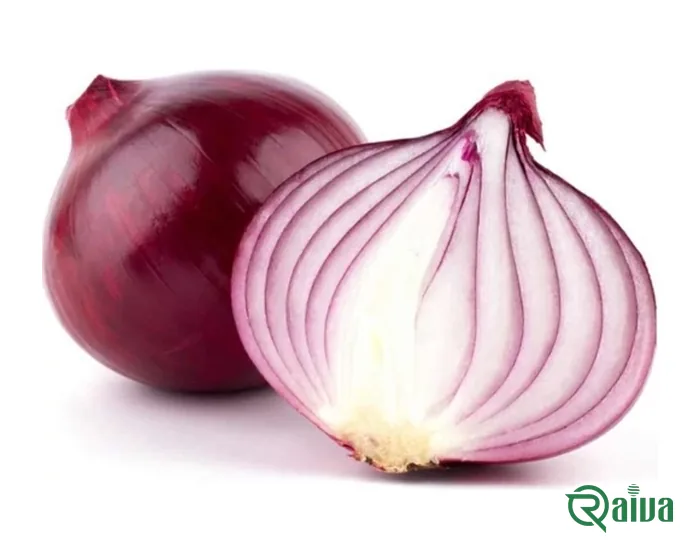 A red onion cut in half beside a whole one