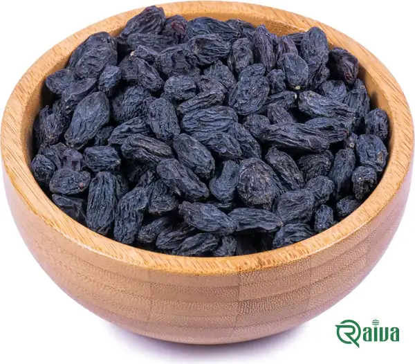 Dark Shahani raisins in a wooden bowl (view 2)