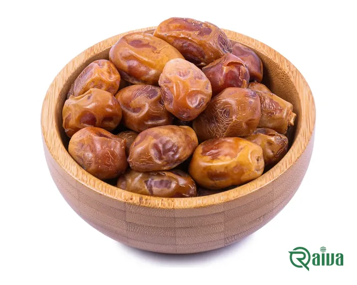 Firm golden-brown Zahedi dates in a wooden bowl